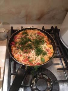 a pizza in a pan on top of a stove at Hotel Diva in Krasnodar