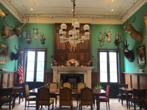 a dining room with a table and a fireplace at The Inn at Houmas House Estate in Darrow