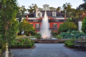 a large house with a fountain in front of it at The Inn at Houmas House Estate in Darrow