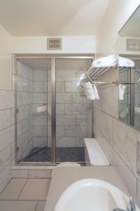 a bathroom with a shower and a sink at Hotel Ruby in Spokane +35 photos