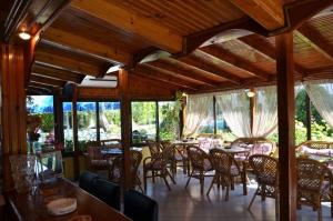 a dining room with tables and chairs and windows at Villa Elia in Limenas