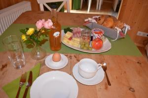 a table with a plate of food and an egg at Bauernhof König in Anger