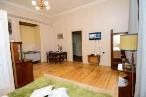 a living room with a bed and a table at Solo Room Apartment in Tbilisi City