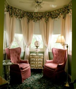 
a living room filled with furniture next to a window at The Sanford House Inn & Spa in Arlington
