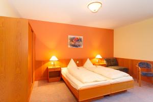 Ένα ή περισσότερα κρεβάτια σε δωμάτιο στο Hotel Tilman