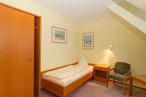 Ένα ή περισσότερα κρεβάτια σε δωμάτιο στο Hotel Tilman