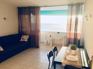 a dining room with a table and a view of the ocean at Feel the Breath of the Ocean in Puerto de Santiago