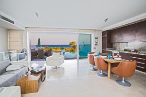 a kitchen and living room with a view of the ocean at Leana Front Line Villa in Protaras