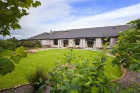 a large house with a large yard with a large lawn at Buchan Braes Hotel in Peterhead