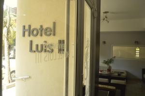 
a sign on a wall in front of a door at Hotel Luis III in Mar del Plata
