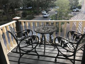 a table and two chairs on a balcony at Foley House Inn in Savannah +116 photos