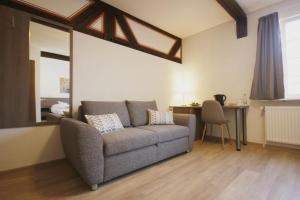 a living room with a couch and a table at Gästehaus zur Sonne in Bad Wimpfen