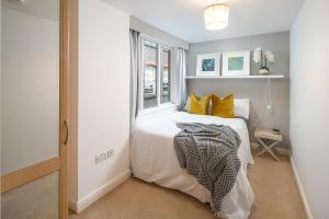 a small bedroom with a bed and a window at Square Mile Residences in London