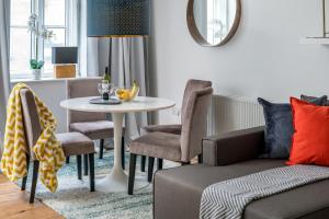 a living room with a table and chairs at Square Mile Residences in London