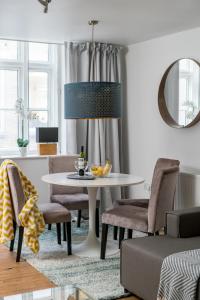 a living room with a white table and chairs at Square Mile Residences in London