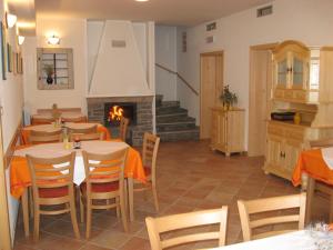 a dining room with tables and a fireplace at Pension Na Meji in Pivka