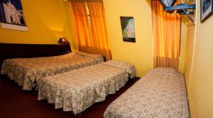 Posteľ alebo postele v izbe v ubytovaní Hostal Iquique