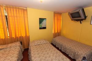Cama ou camas em um quarto em Hostal Iquique