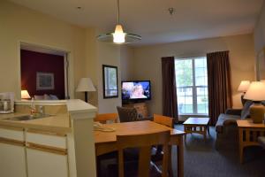 a living room with a kitchen and a dining room at Baymont by Wyndham Wichita East in Wichita