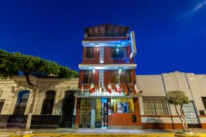 a building with a clock tower in front of it at Hostal Iquique in Lima