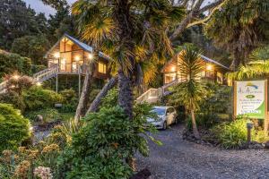 a house with a car parked in front of it at Abri Apartments in Paihia