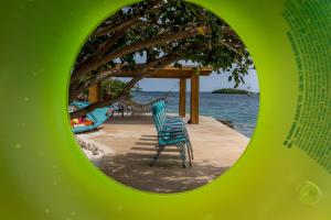 a chair sitting in front of the water at Serene by the Sea in Savaneta