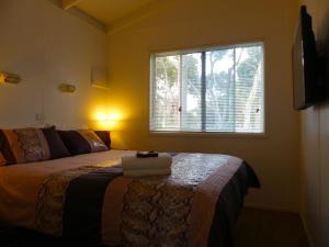 
A bed or beds in a room at Pelican Waters Holiday Park
