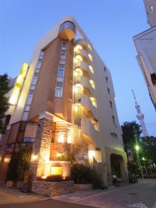 a large building with lights on the side of it at Hotel Mju-Adult Only in Tokyo