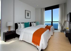Ένα ή περισσότερα κρεβάτια σε δωμάτιο στο Montigo Resort Nongsa +67 φωτογραφίες
