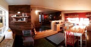 a living room filled with furniture and a fire place at Hostal Treehouse Patagonia in Puerto Natales