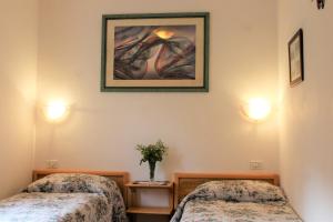 Habitación con 2 camas y una foto en la pared. en Chalet Abetone in Tuscany, en Abetone