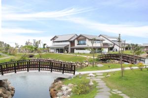 a house with a bridge over a pond at Dancewoods Hotel in Wujie