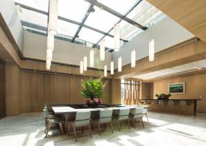 a large dining room with a table and chairs at Dancewoods Hotel in Wujie