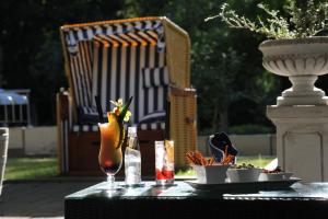 a table with a drink and a plate of food at Waldhotel Rheinbach in Rheinbach