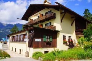 a large building with flowers on the windows at Landhotel Panorama in Garmisch-Partenkirchen