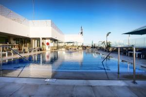 a large swimming pool in front of a building at Hotel Sfax Palace by Plaza Hotels & Resorts in Sfax