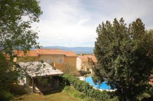 a view of a house and a swimming pool at Apartments Begic by El-Pi Tours in Malinska