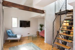 a living room filled with furniture and a stair case at Ateliers de Montmartre ADM in Paris
