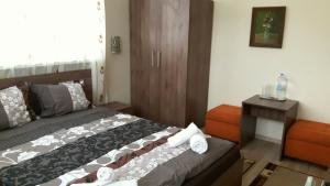 a bedroom with a bed with towels on it at Guest House Radoychevi in Velingrad