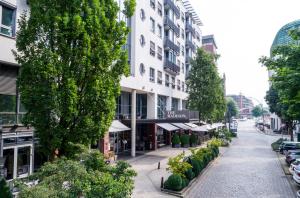 
a large building with many windows and trees at THE MADISON Hotel Hamburg in Hamburg
