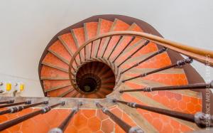 an orange spiral staircase in a building at Résidence Meublée Services in Marseille