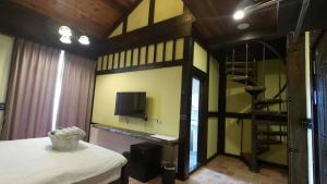 Un dormitorio con una litera con un televisor en la pared. en Brest Bed & Breakfast, en Puli