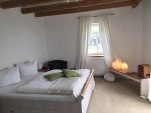 a white bedroom with a bed and a window at Schwedenfrieden in Bielefeld
