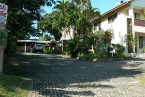 a cobblestone street in front of a building at Fisheagle Accommodation in St Lucia