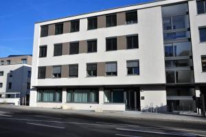 a white building on the side of a street at Apartments am Freizeitpark in Kriftel