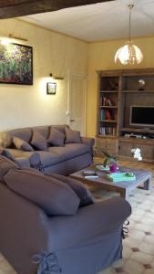 a living room with couches and a coffee table at Gite de la ferme du couvent in Boran-sur-Oise