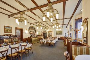 a dining room with tables and chairs at Hotel Hořec in Pec pod Sněžkou