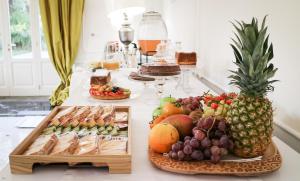 a table with a buffet of fruit and pastries at Palazzo dei Concerti in Torre Annunziata +26 photos