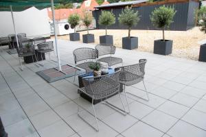 a group of chairs and tables on a patio at Schlossberghotel Greiz in Greiz