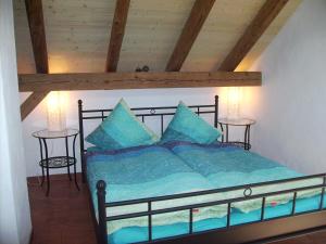 1 Schlafzimmer mit einem Bett mit blauer Bettwäsche und 2 Tischen in der Unterkunft Mountain-Panorama in Meiringen